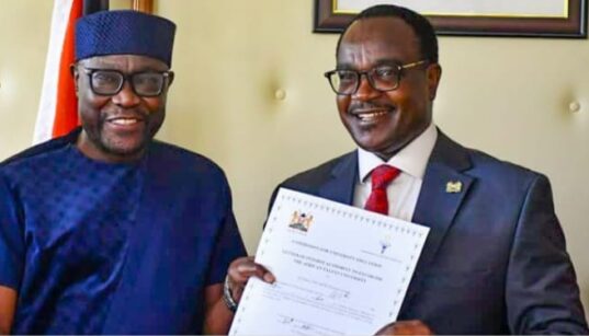 CS Education Julius Ogamba awarding a certificate to African Talent University