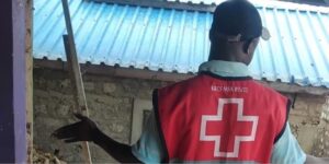 A Red Cross official assesing damage caused by floods