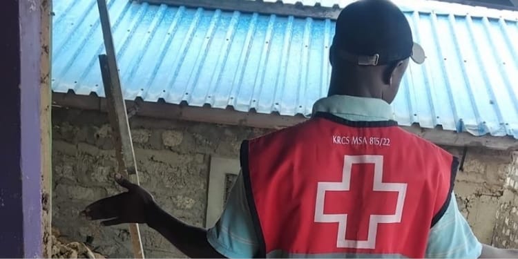 A Red Cross official assesing damage caused by floods