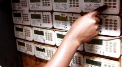 a person feeding in units at a token meter