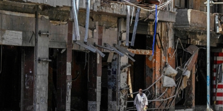 UN humanitarian coordinator Denise Brown highlights the worsening crisis in Sudan as a damaged residential building stands in Khartoum during ongoing fighting on April 16, 2026.