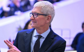US businessman Tim Cook gestures as he departs a business leaders reception on January 21,2026 in Davos