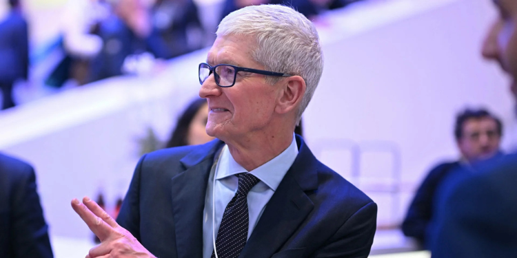 US businessman Tim Cook gestures as he departs a business leaders reception on January 21,2026 in Davos