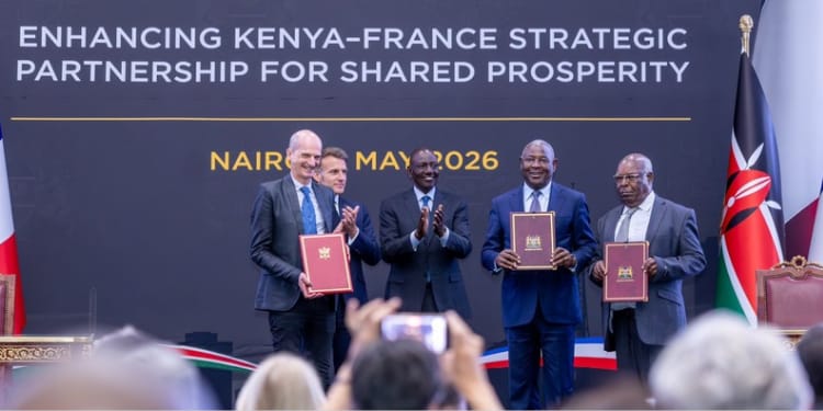 President William Ruto and President Emmanuel Macron of France stand alongside senior French and Kenyan government ministers and diplomats during a bilateral signing ceremony at State House Nairobi. PHOTO/Equity X