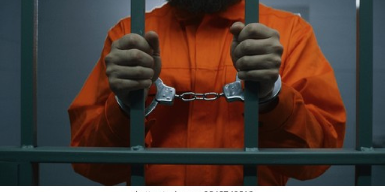 Photo of a man in a police cell with handcuffs. PHOTO/ File