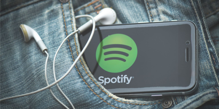 A phone in someone's pocket bearing the logo of Spotify with earphones on it. PHOTO/ File