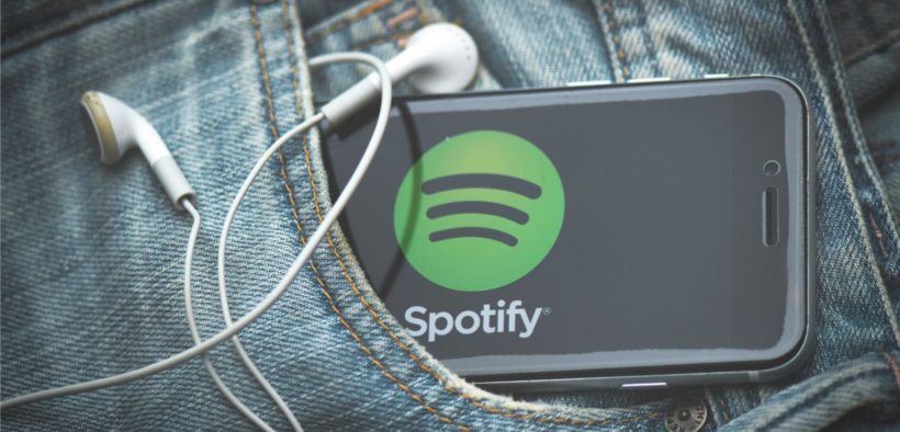 A phone in someone's pocket bearing the logo of Spotify with earphones on it. PHOTO/ File