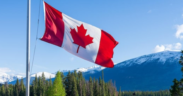 A Canadian flag with a background of Canada landscape. PHOTO/ File