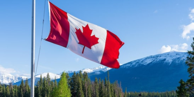 A Canadian flag with a background of Canada landscape. PHOTO/ File
