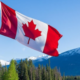 A Canadian flag with a background of Canada landscape. PHOTO/ File