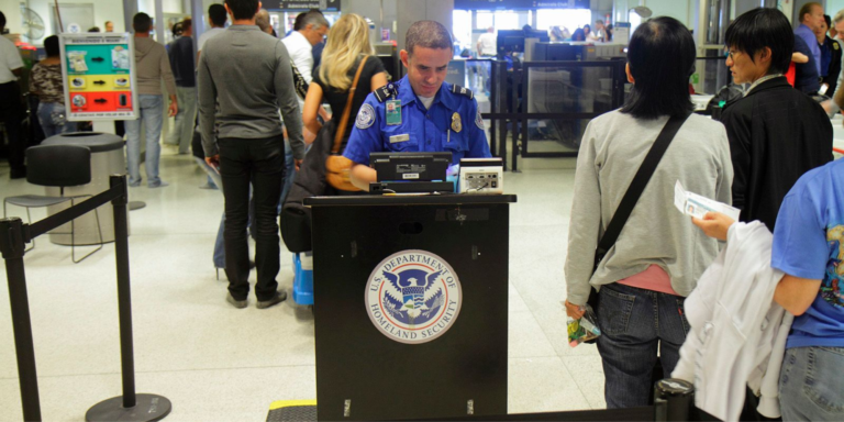 A security officer from the US Department of Homeland Security conducts a security check at the airport for those visiting the US. PHOTO/ DHS