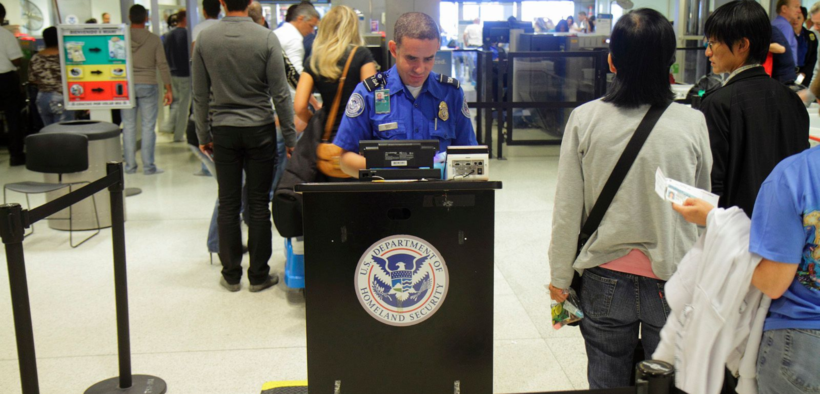 A security officer from the US Department of Homeland Security conducts a security check at the airport for those visiting the US. PHOTO/ DHS
