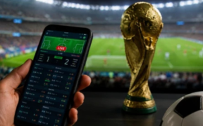 An AI generated image of a person holding a phone showing a fictious betting site, a world cup trophy and a football pitch for illustration purposes. PHOTO/ File