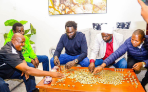 Ol Kalou residents join Nyandarua Senator John Methu as they count Ksh 10 contributions collected to buy a suit for MP aspirant Sammy Ngotho, turning an insult into a show of unity ahead of the by-election. PHOTO/ Citizen Digital