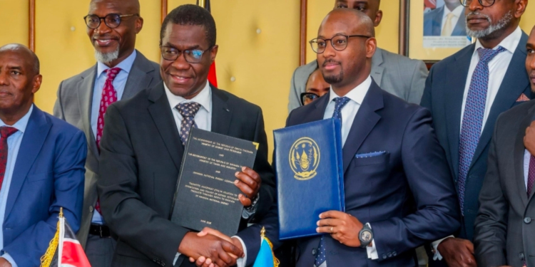 Kenya's Cabinet Secretary for Energy and Petroleum, Opiyo Wandayi and Rwanda's Minister of Infrastructure, Jimmy Gasore, hold signed documents during a historic bilateral agreement ceremony in NairobiPHOTO/Wandayi X