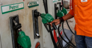 Fuel station attendant returning a fuel pump after fuelling in Kenya. Photo/ file