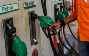 Fuel station attendant returning a fuel pump after fuelling in Kenya. Photo/ file