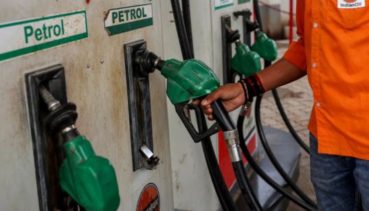 Fuel station attendant returning a fuel pump after fuelling in Kenya. Photo/ file