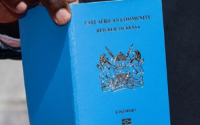 Photo of a Kenyan man holding a passport. PHOTO/ Directorate of Immigration Services