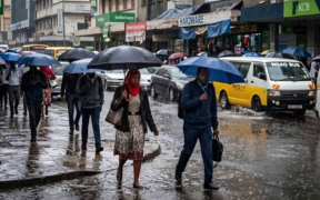 A photo of kenyans walking under the rain . Photo/ Courtesy