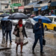 A photo of kenyans walking under the rain . Photo/ Courtesy