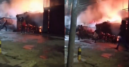A photo showing resident trying to control the fire flame using water . Photo/ Courtesy