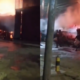 A photo showing resident trying to control the fire flame using water . Photo/ Courtesy