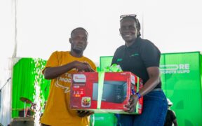 A customer receives a microwave during Safaricom’s PATA MORE campaign launch at Misori Beach, Usenge, Siaya County. Photo/ Safaricom