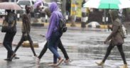 Kenyans walking in the rain PHOTO/Standard