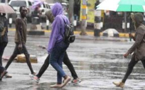 Kenyans walking in the rain PHOTO/Standard